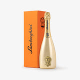 Gold champagne bottle with Lamborghini branding next to an orange box on a white background